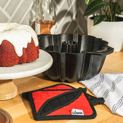 Cast Iron Fluted Cake Pan with Red Potholders